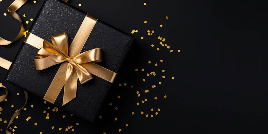 Gift box and golden ribbon on black background with glitter. Bla 6 เหตุผลในการเลือกโรงงานของพรีเมี่ยมที่น่าเชื่อถือ